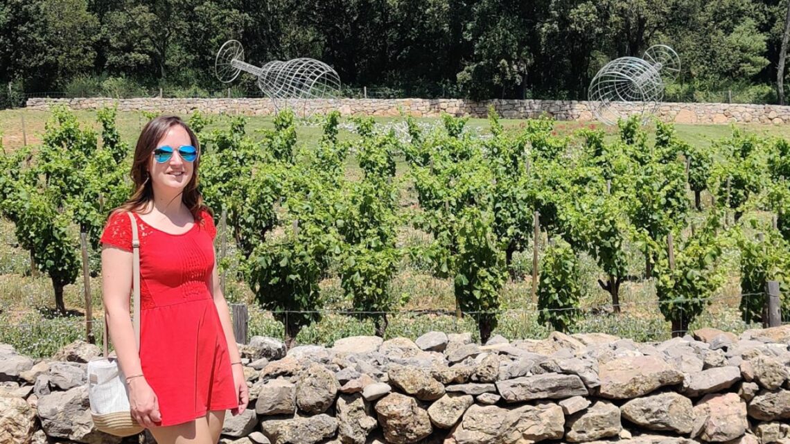 Exploring Côtes de Provence - A guide to the region. Me in a red dress in front of vines