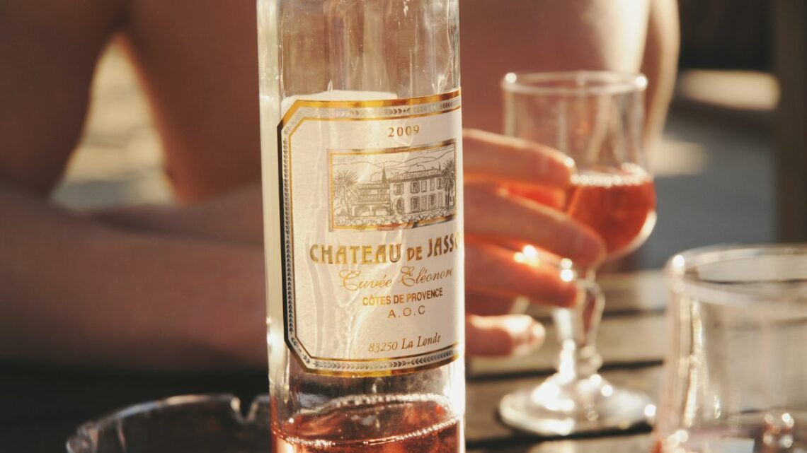 Cinsault Grape Variety In Provence - a bottle of rosé wine with a glass of rosé wine