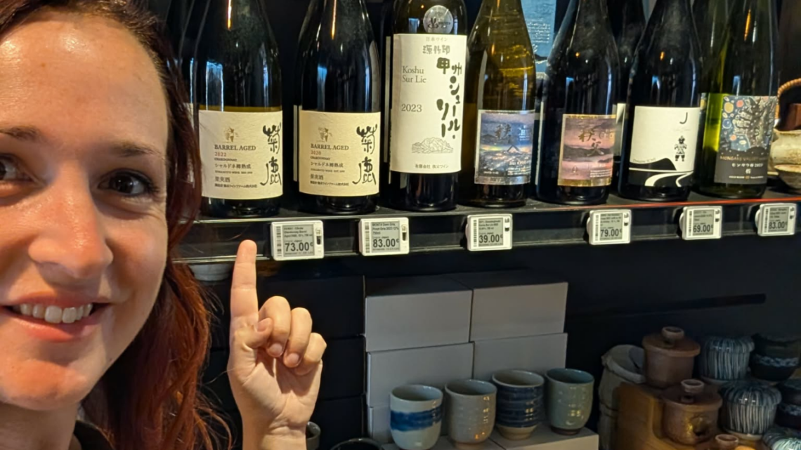 Me in front of Japanese wines on a shelf