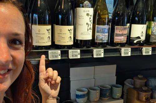 Me in front of Japanese wines on a shelf